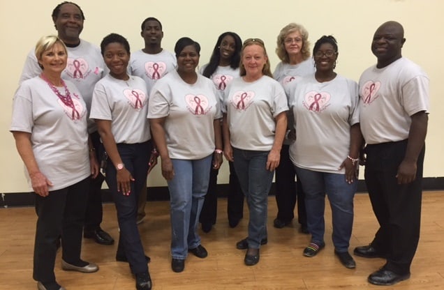 Staff members of Nova Academy pose in their Breast Cancer Awareness T-shirts designed by teacher Sade Burkman and her students.